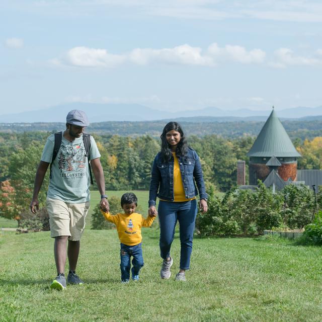 Two parents walking with young child between them