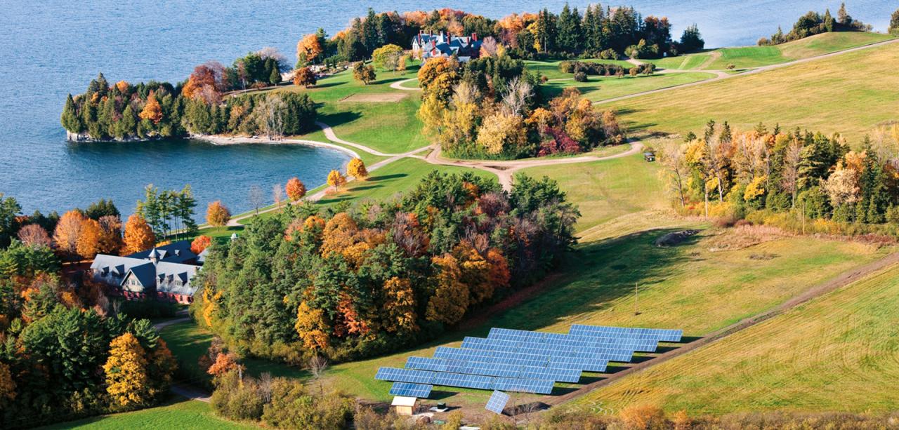 aerial view of solar panels, inn, lake, pasture