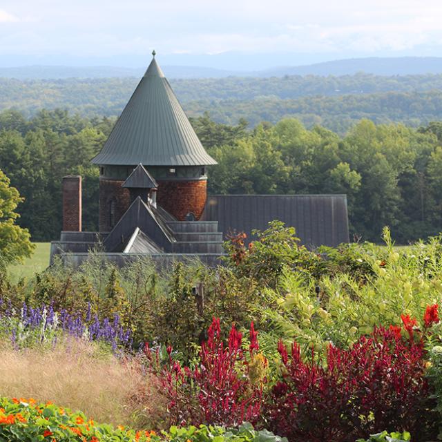 Education garden with Farm Barn tower behind it.