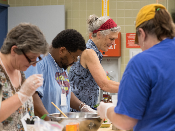 Abbie Nelson works with school nutrition professionals in Milton High School's cafeteria.